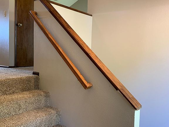 Stairs to living room, powder bath, kitchen, dining room and upper deck