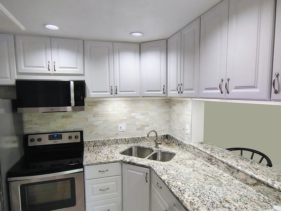 2026 remodeled kitchen with granite countertops, polished-marble backsplash, SS appliances, special lighting accents