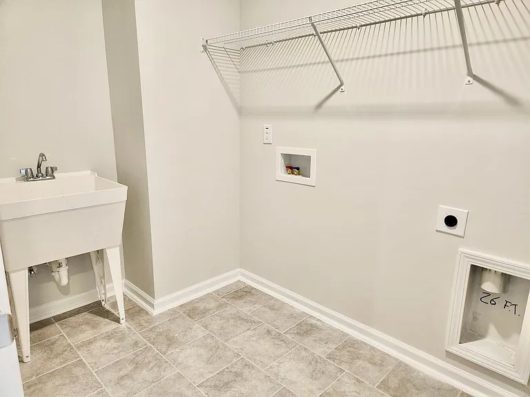 laundry room with a sink. Washer & dryer will be provided