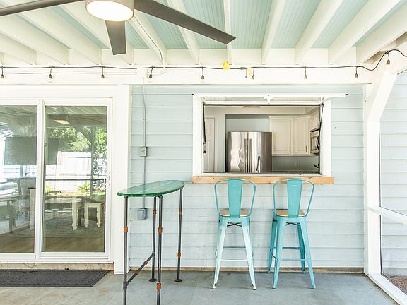 The pass-through between the kitchen and the screened porch is one of our favorite features of this home...ideal when entertaining and grilling out!