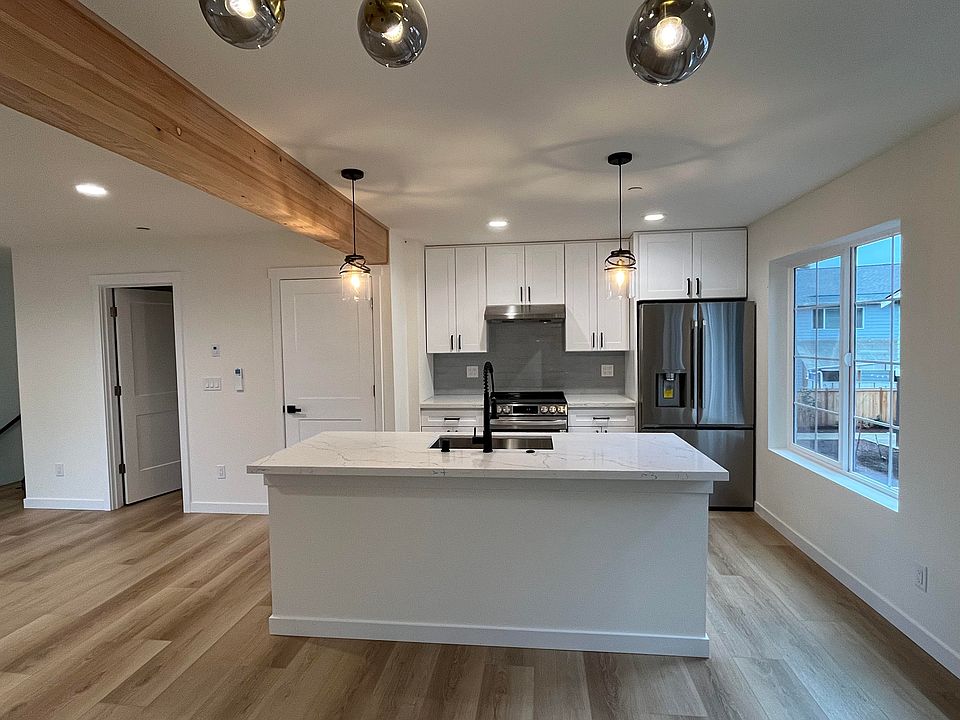 Spacious open plan kitchen with generously sized island and lots of natural light.
