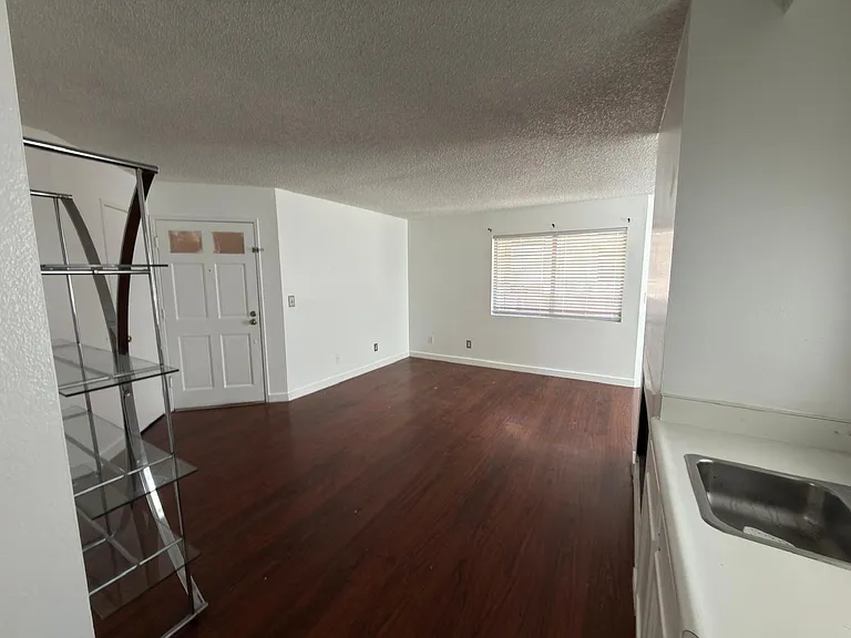 View from hallway to the living room. Wet bar on the right side.
