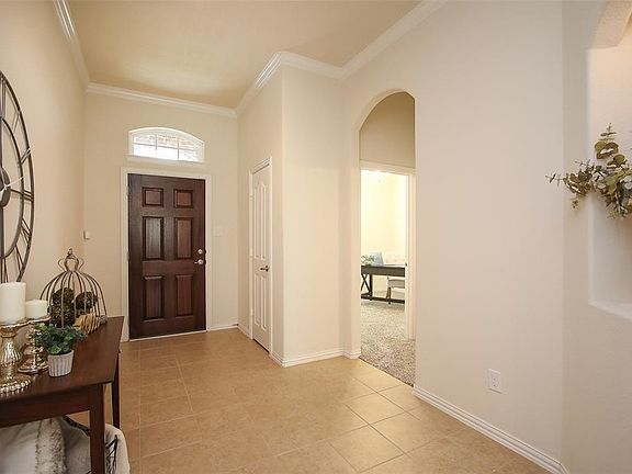 When entering the tiled foyer, notice the benefit of location of the arched window over the door and the guest closet. The entry to the 2 bedrooms and their shared bath is right off the front foyer. .