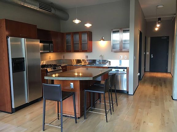 Kitchen features big island, gas stove, stainless steel appl