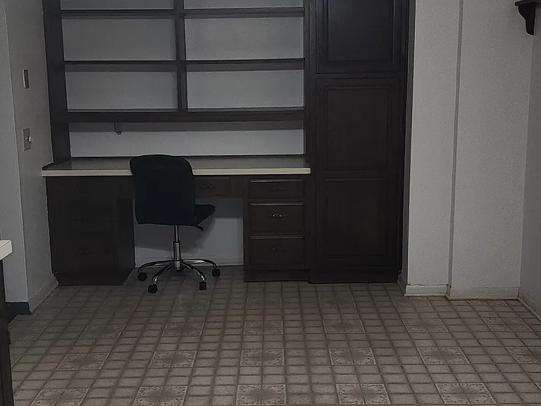 Looking through kitchen to Breakfast area and desk with book shelves.