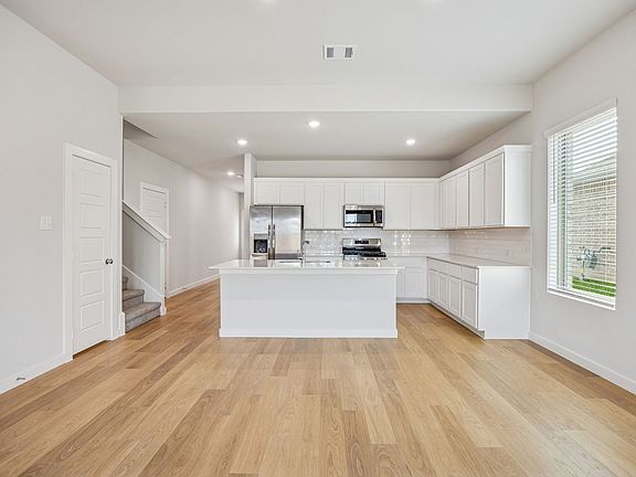 Kitchen in the Stanley II home plan by Trophy Signature Homes - REPRESENTATIVE PHOTO