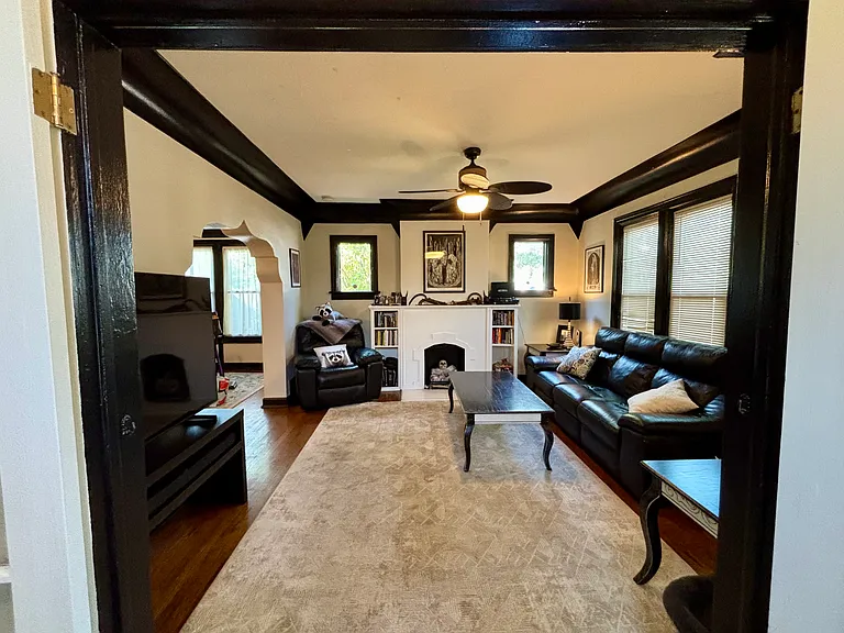 Shared living room with seating, fireplace, TV