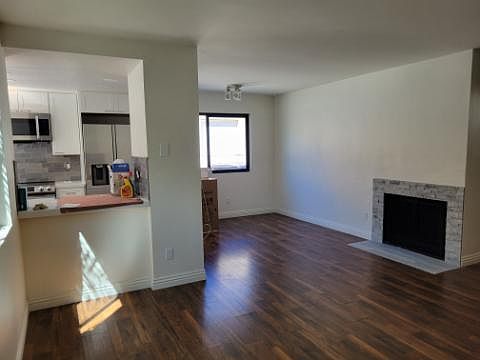 Entry view of living room, fireplace, kitchen
