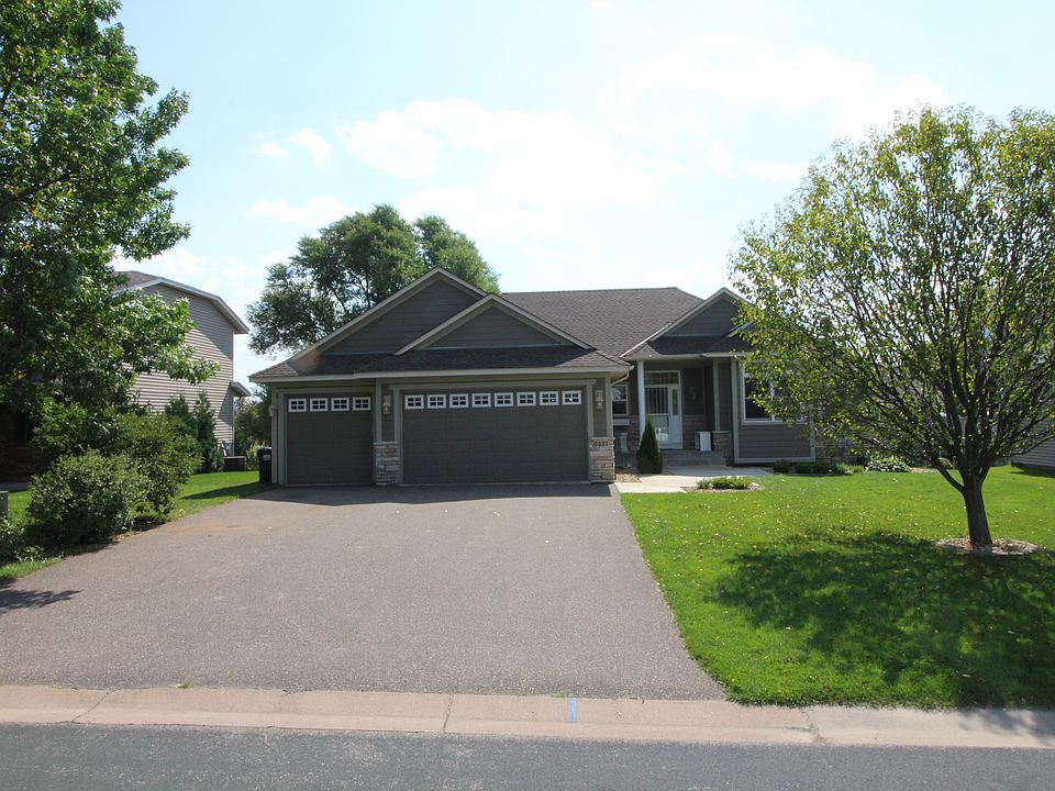Front of home, wide driveway