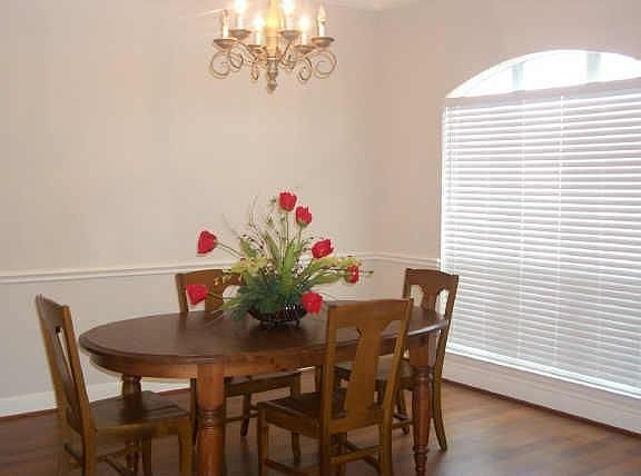 Large window, crown molding, & chair molding drees up the dining room