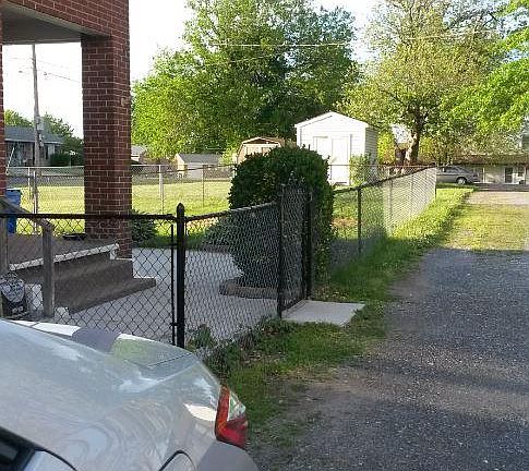 Large, partially fenced, back yard.  Storage shed.