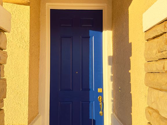 Main entrance door freshly painted in stylish navy blue, creating a bold and welcoming first impression!