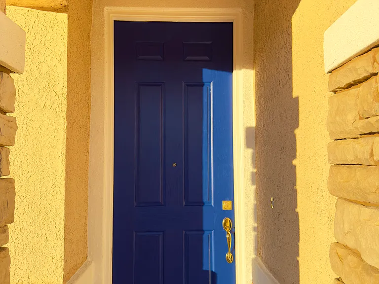 Main entrance door freshly painted in stylish navy blue, creating a bold and welcoming first impression!