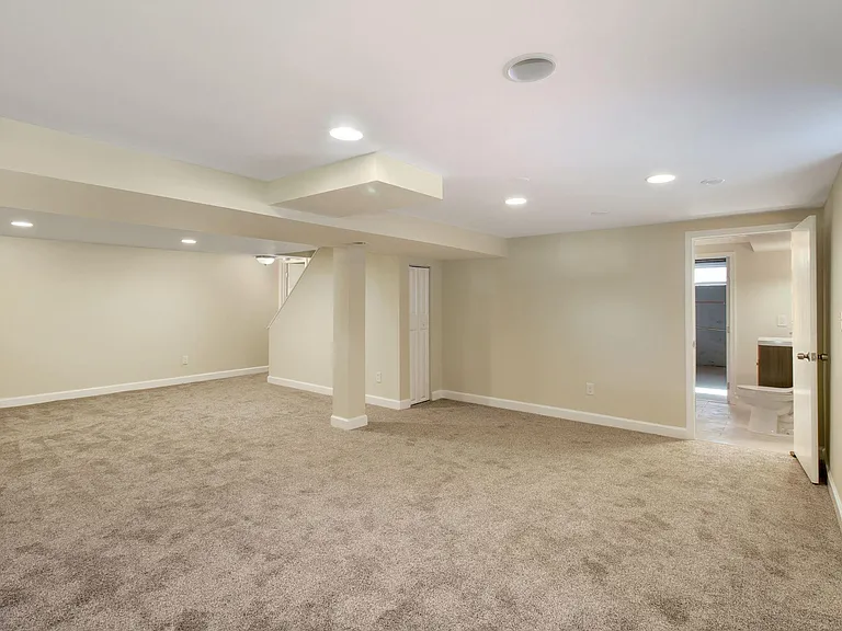 Finished basement with bathroom & wall-to-wall carpeting.