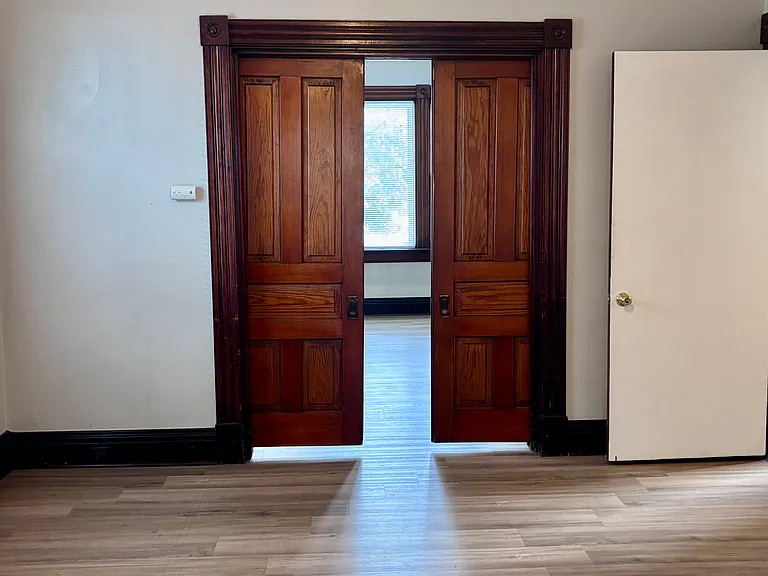 Pocket doors separate the living room/dining room from the bedroom.