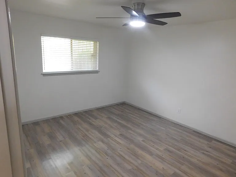 Second bedroom with one-half bath with stack washer and dryer, and walk-in closet.