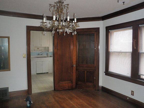 Dining room with built-in corner china cabinets and chandelier.