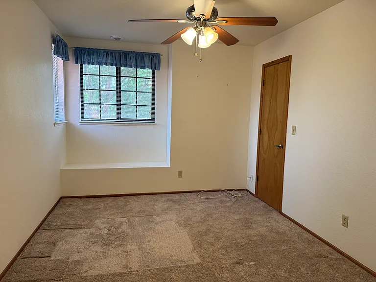 Bedroom 1 with walk in closet and ceiling fan. Built in reading nook.