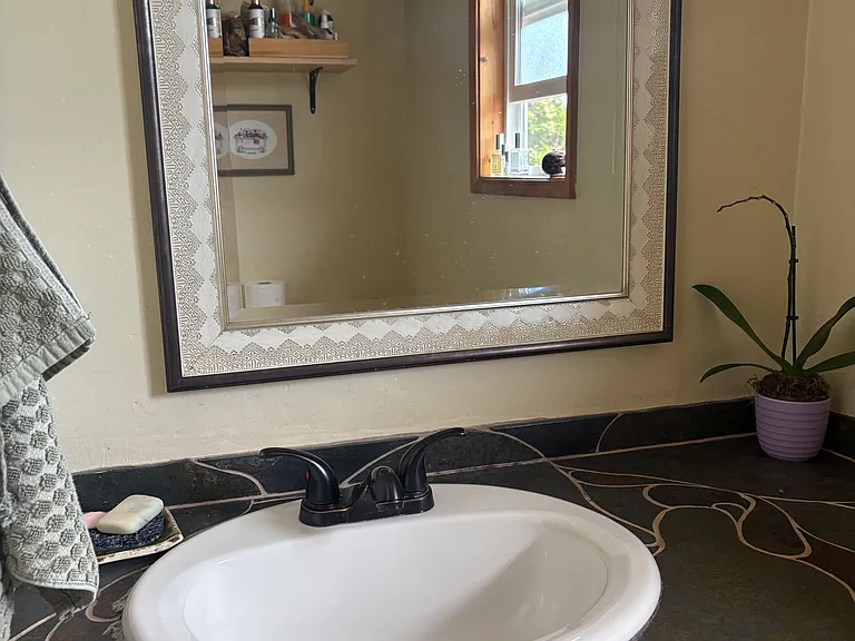 This is a photo of the bathroom sink area with tile.