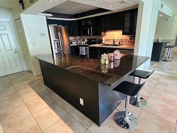 large kitchen island with stainless steel appliances