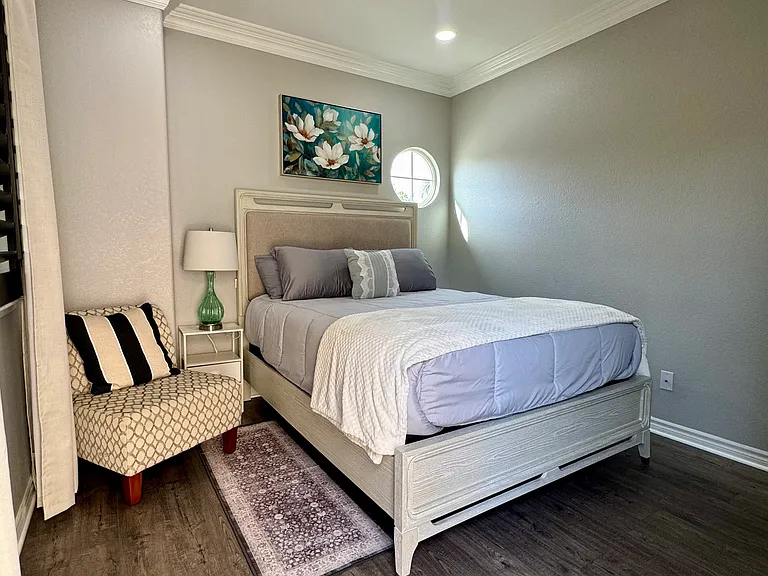 Private comfortable bedroom with premium queen bed and mattress, shutters and blackout curtains, recessed lighting, and ceiling fan.