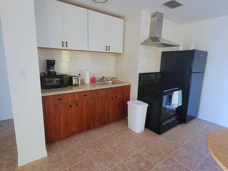 Fully equipped kitchen with stove, oven, refrigerator, microwave, and coffee maker.