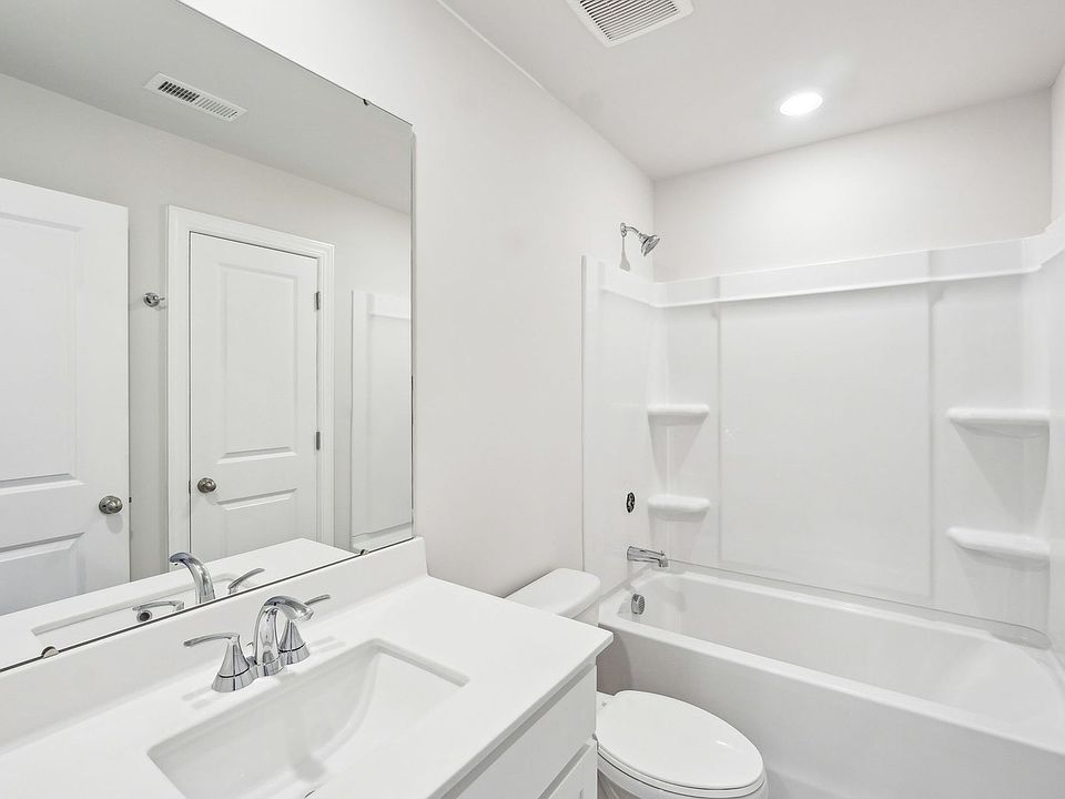 The secondary bathroom features an oversized shower tub for guests.