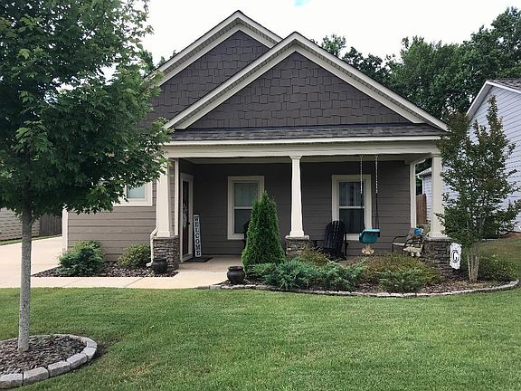 Well landscaped yard has sprinkler system.