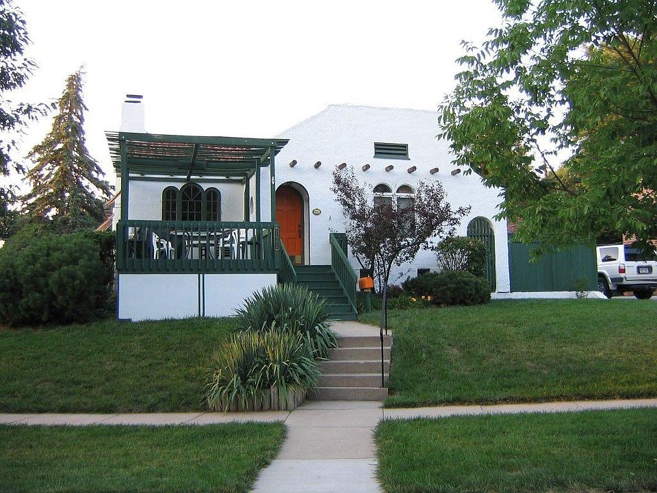 unique spanish style home with large deck on front