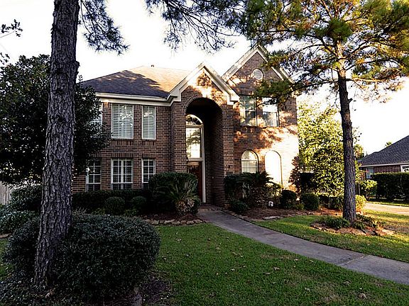 This home has a large front yard and is beautifully landscaped.