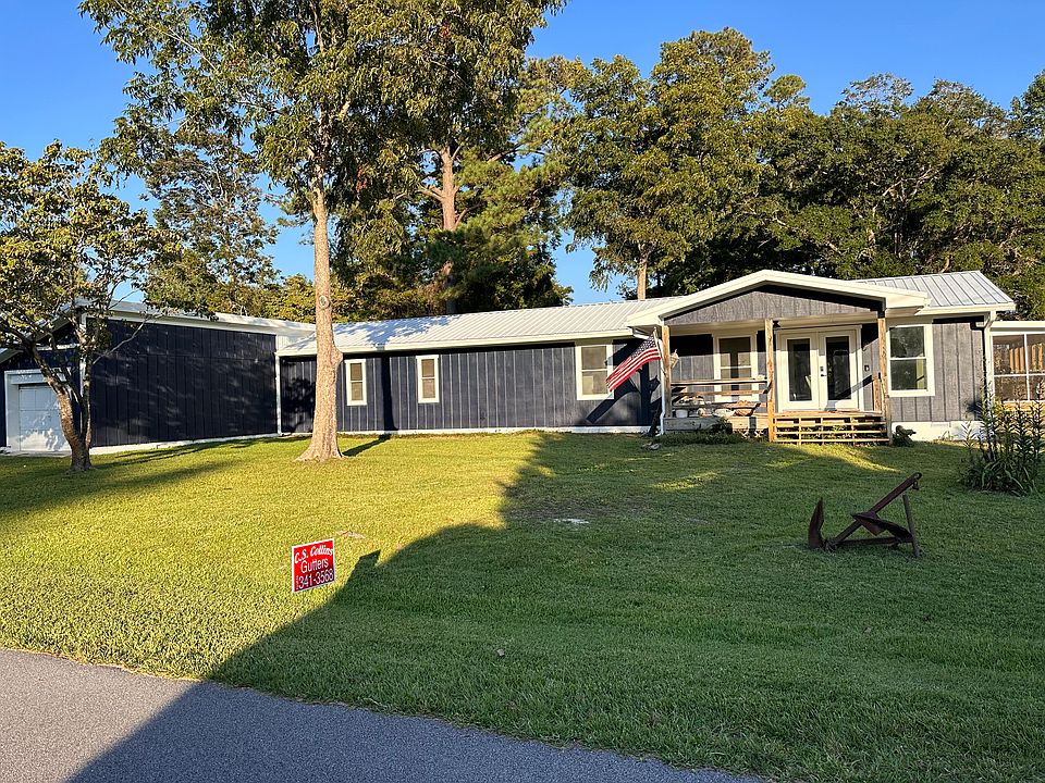 Full outside view with attached shop and storage at the end