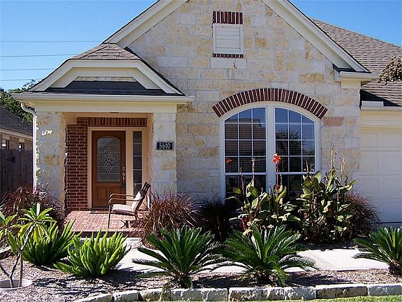 Attractive landscaping invites you into this well maintained home.