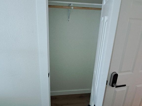 Dedicated closet with hanging rod and upper shelf offers practical storage for clothing and everyday essentials.