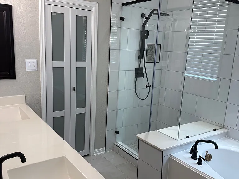 Master Bathroom with double vanity, shower, and tub