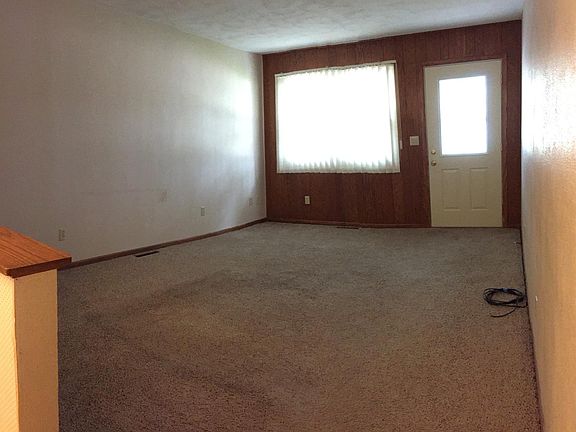 View into the living room from the kitchen. (front entry doo