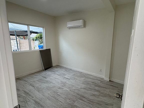Large bedroom with mini split air conditioning in bedroom.