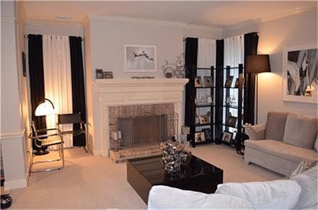 Snuggle up near the Fireplace in the Formal Living Room . Crown Molding found here and throughout th