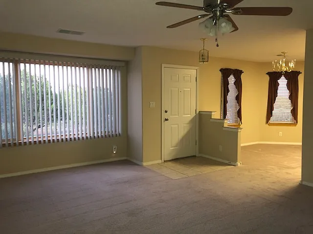 View from bedroom towards front of home living room, dining area shown.