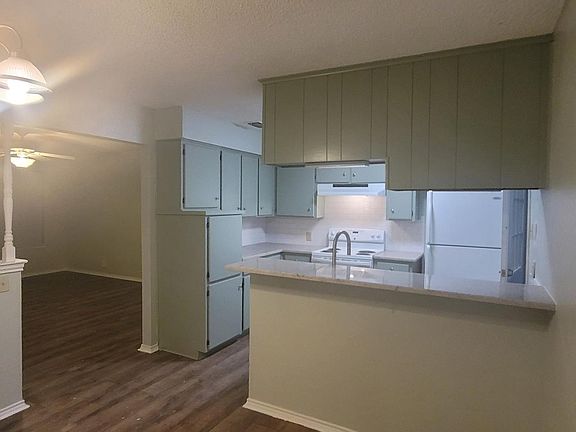 dining room looking into kitchen and living room
