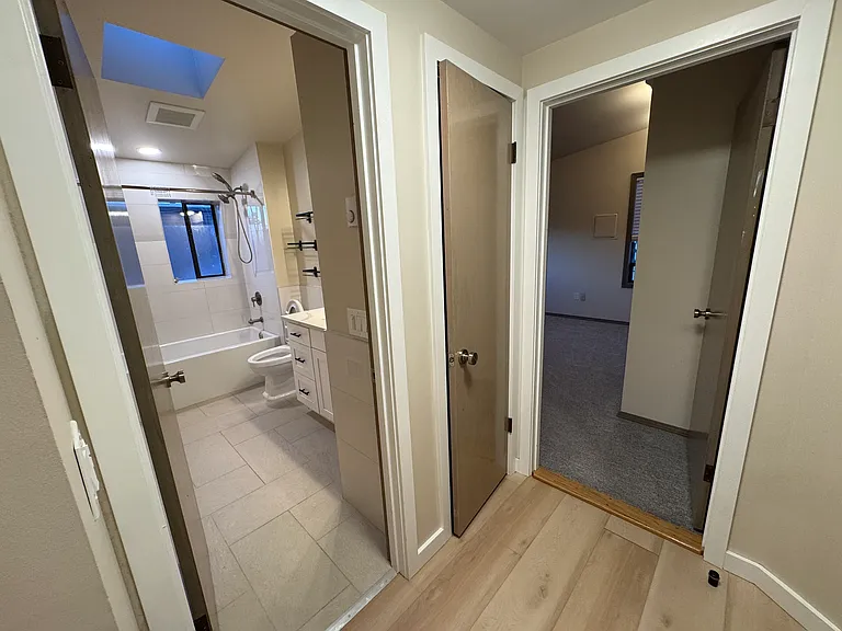Bathroom, linen closet, and primary bedroom