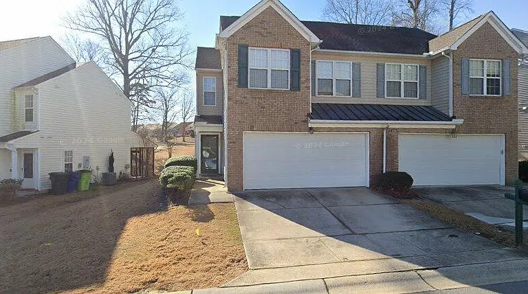 Front with 2 car garage and driveway