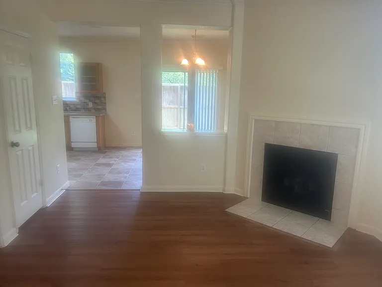 Living room with fireplace, access the to kitchen and dining room.