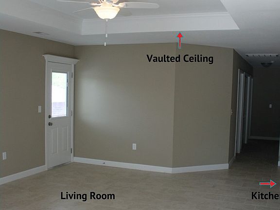 Living Room with vaulted ceilings and fan