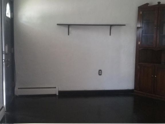 livingroom with antique hutch; landlady and landlord will leave for tenant's use during lease.