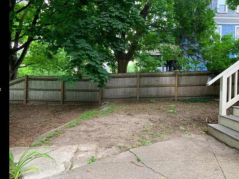 Back yard by steps to kitchen