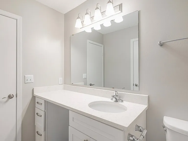 Renovated bath featuring modern countertops, updated fixtures, and generous space for everyday routines.
