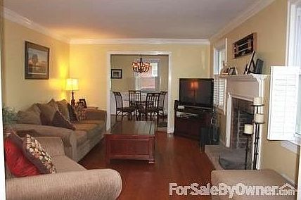 Living Room : Brick fireplace with mantel. Double pane windows with plantation shutters.