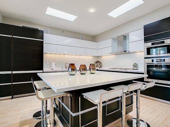 Paneled Appliances (Sub Zero) Refrigerator, Siele Oven/Micro Combo, Gas Cooktop, Flip up Upper Cabinets and Pull Out Drawers