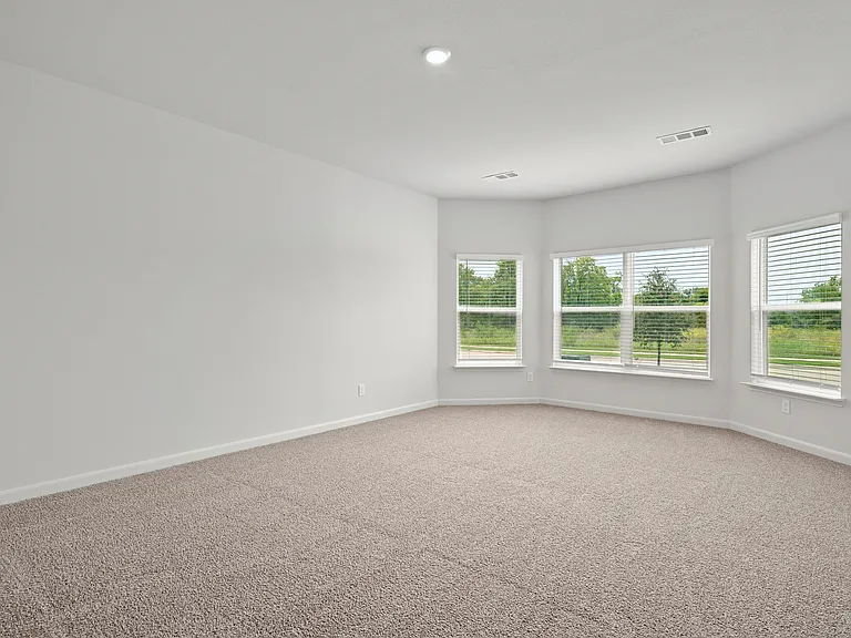 The master bedroom has three large windows that let in great, natural light.