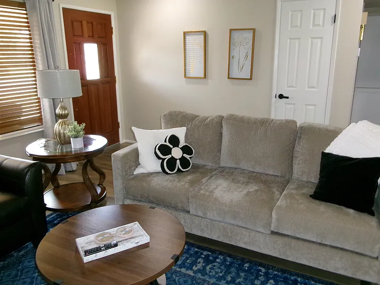 Living room is right inside the front door. Brand new sofa April 2026.
